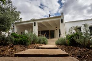 a white house with a pathway in front of it at Hoof House in Riebeek-Kasteel