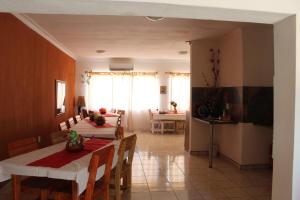 a kitchen and dining room with two tables and chairs at Ruacana Guest House in Ruacana