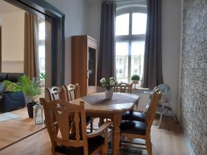 a dining room with a table and chairs at Meeresleuchten 1 in Emden