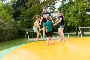 a group of children playing on a trampoline at De Vuursteen | 10 - 40 pers. in Losser