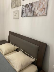 a bed in a room with two pillows on it at Irini Apartment in Hanioti
