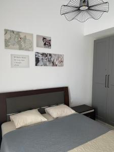 a bedroom with a bed and a chandelier at Irini Apartment in Hanioti