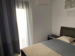 a bedroom with a bed and a window at Irini Apartment in Hanioti +32 photos