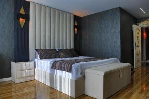 a bedroom with a king sized bed and a stool at Gelevera Park - Otel Spa Restaurant in Espiye