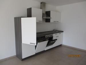 a kitchen with white cabinets and a stove top oven at Parsberger Ferienhaus 23 a in Parsberg