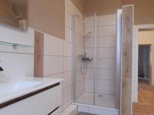 a shower with a glass door in a bathroom at Meeresleuchten 1 in Emden +8 photos