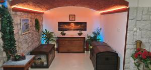 a hallway with two benches and a dresser in a room at Apartments Giron in Dubrovnik
