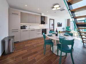 a kitchen and dining room with a table and chairs at Rezidence Třebíč in Třebíč