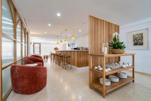 a living room with a kitchen and a dining room at Hotel Boutique Petit París in Port de Pollensa
