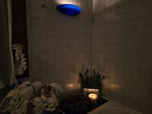 a bathroom with a blue light above a bath tub at B&b Ca'Baracca Bellavista in Bassano del Grappa