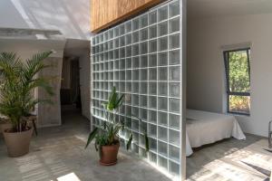 a room with a wall of glass blocks at Masseria Noja in Noci