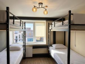 two bunk beds in a room with a window at Shpola Central Hotel in Shpola