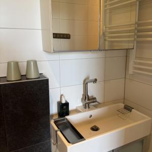a kitchen with a sink and a counter top at Inn de Vijf Sinnen in Geertruidenberg +7 photos