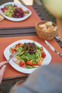 two plates of food on a table with plates of food at Hotel Eisbach in Ransbach-Baumbach
