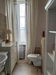 a bathroom with a toilet and a sink and a window at La Maison de Marie in Blaye +19 photos