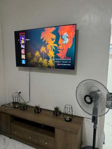 a flat screen tv hanging on a wall at Private Villa in Masbate