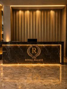 a sign for the royal palace in a lobby at The Royal Palace Uttara in Dhaka