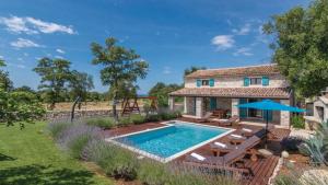 a villa with a swimming pool and a house at Villa Sabrane by Villas Guide in Bale