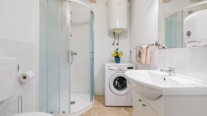 a white bathroom with a washing machine and a sink at Villa Sabrane by Villas Guide in Bale