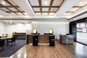 an office with two desks and chairs in a room at CHECK inn Taipei Nanjing in Taipei