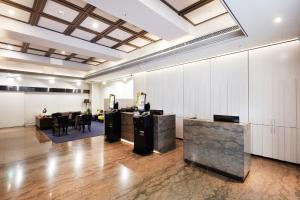a lobby with desks and tables in a building at CHECK inn Taipei Nanjing in Taipei