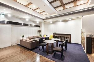 a living room with a couch and a table and chairs at CHECK inn Taipei Nanjing in Taipei +61 photos
