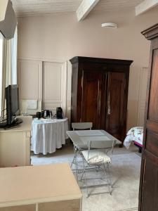 a room with a table and a tv and a table at La Maison de Marie in Blaye
