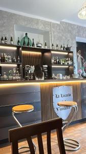 a restaurant with a bar with a table and a stool at La Locanda Del Viandante in Bellano