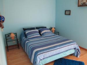 a blue bedroom with a bed with two lamps at Gite à la Ferme de la Petite Noé - in Tracy-sur-Mer