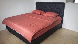a bed with a black frame and red sheets and pillows at Villa Kay View in Sampal 2 +21 photos