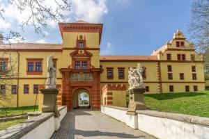 a large yellow building with a pathway leading to it at Rezidence Třebíč in Třebíč