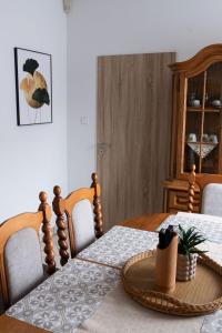 a dining room with a wooden table and chairs at Apartment Sučany 3 in Sučany