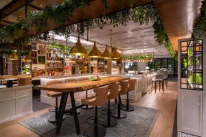 a restaurant with a large wooden table and chairs at Trident Nariman Point in Mumbai