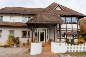 a house with a tiled roof at Pension Herkules in Koserow