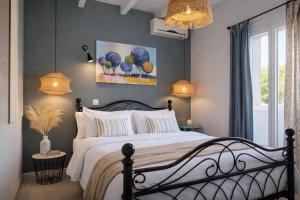 a bedroom with a bed and a painting on the wall at Hara Luxury House in Gaios