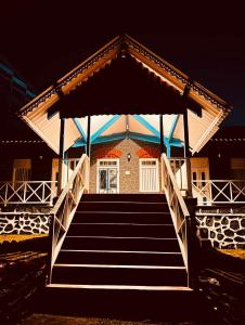 a staircase leading to a house with a gazebo at The Coastal Nest in Daman +10 photos