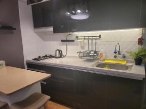 a kitchen with a sink and a stove at Forêt Guest House Gangnam in Seoul +89 photos