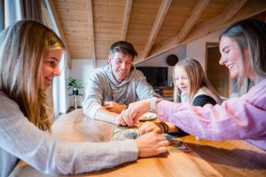 a group of people sitting around a table at Bader Suites - Apartments in Garmisch-Partenkirchen +62 photos