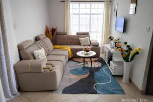a living room with a couch and a table at Nolan's Comforts Kitengela in Kitengela 