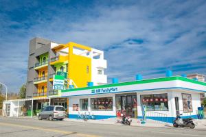 a yellow and white building on the side of a street at Atami Penghuwan in Magong