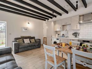 a kitchen and living room with a table and a couch at 3 Bed in Crieff oc-90794 in Comrie