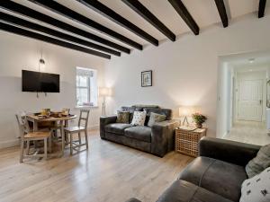 a living room with a couch and a table at 3 Bed in Crieff oc-90794 in Comrie