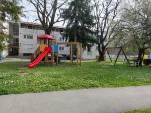 a playground with a slide in a park at Studio Apartman Tara in Daruvar