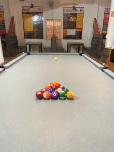 a pool table with a bunch of balls on it at Happy Bear Hostel Phu Quoc in Phú Quốc