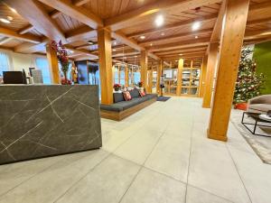 a lobby of a building with a table and chairs at Bergresort Gerlitzen in Treffen +51 photos