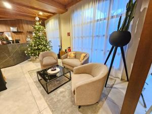 a living room with a christmas tree and chairs at Bergresort Gerlitzen in Treffen