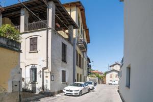 a white car parked on the side of a street at Albavilla Stone Loft in Albavilla
