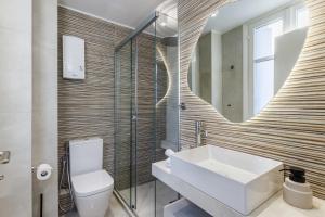a bathroom with a sink and a mirror at The Blue Door - Skopelos in Skopelos Town +31 photos
