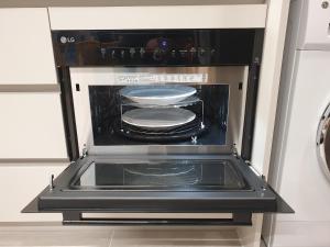 an oven with plates and pans inside of it at 광안리 오션뷰 in Kwangan-dong