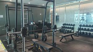 a gym with rows of equipment in a room at 광안리 오션뷰 in Kwangan-dong